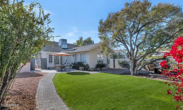 a view of a backyard with sitting area and furniture