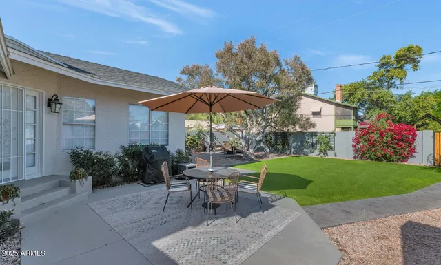 a view of a backyard with sitting area