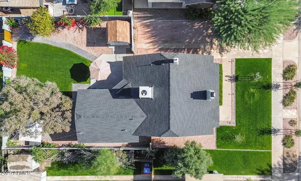 a view of a house with backyard and sitting area