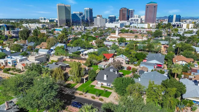 an aerial view of residential houses with outdoor space and trees