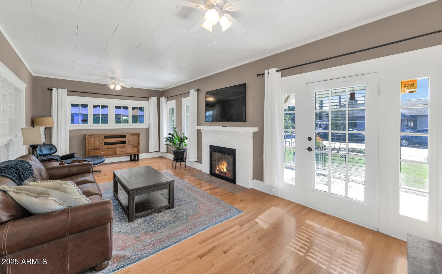 60 East Hoover Avenue Phoenix, AZ 85004 - Photo 4 of 24 a living room with furniture a flat screen tv and a fireplace