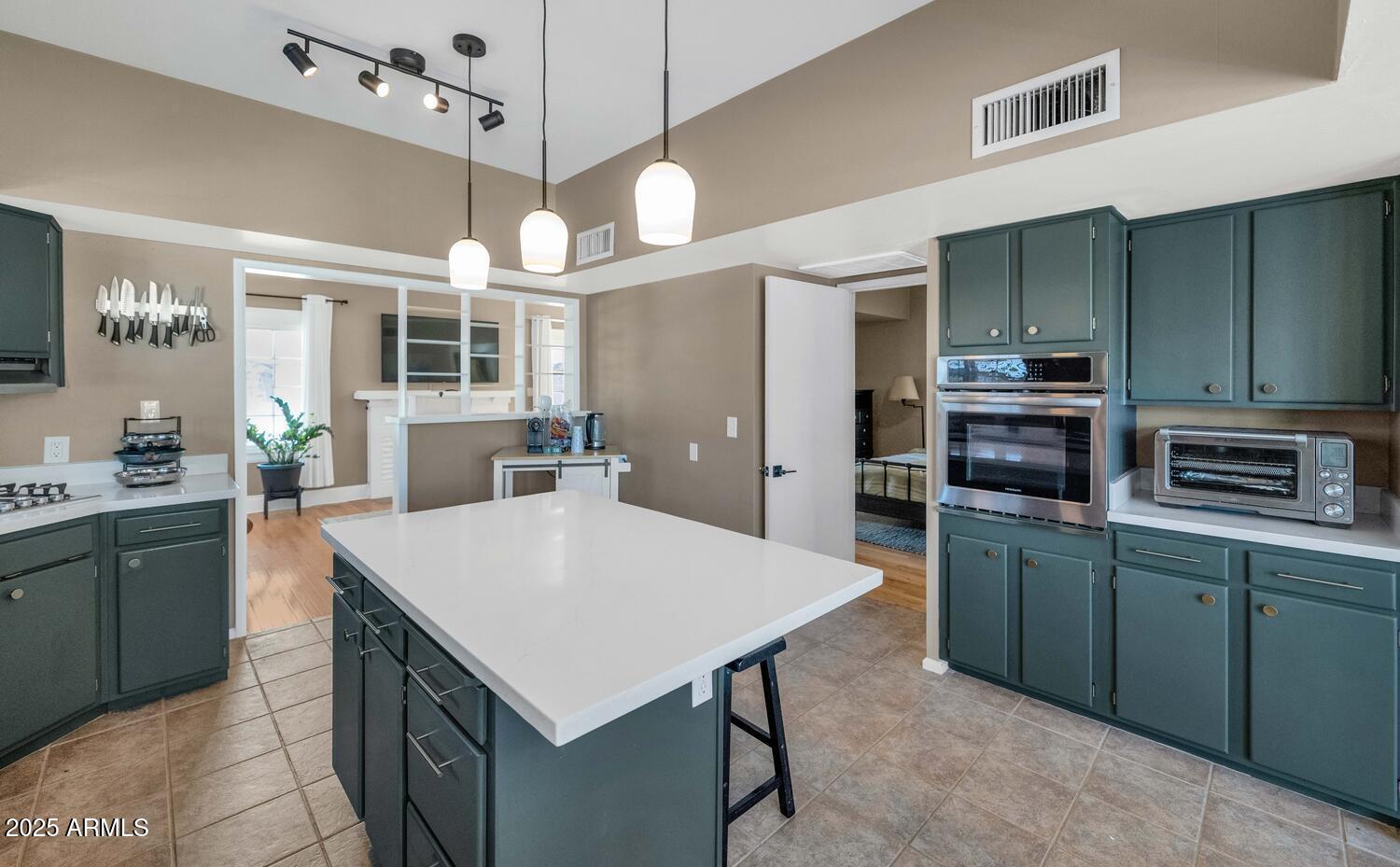 60 East Hoover Avenue Phoenix, AZ 85004 - Photo 8 of 24 a kitchen with kitchen island a sink stove and refrigerator