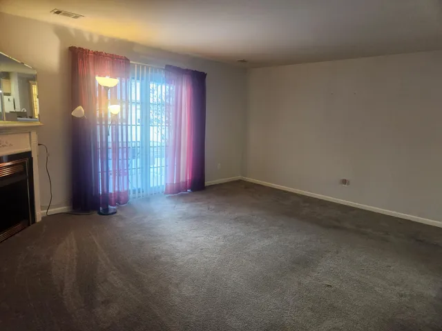 an empty room with windows and closet