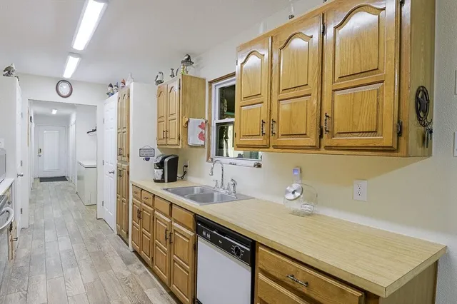 a spacious bathroom with a granite countertop sink a mirror and a shower