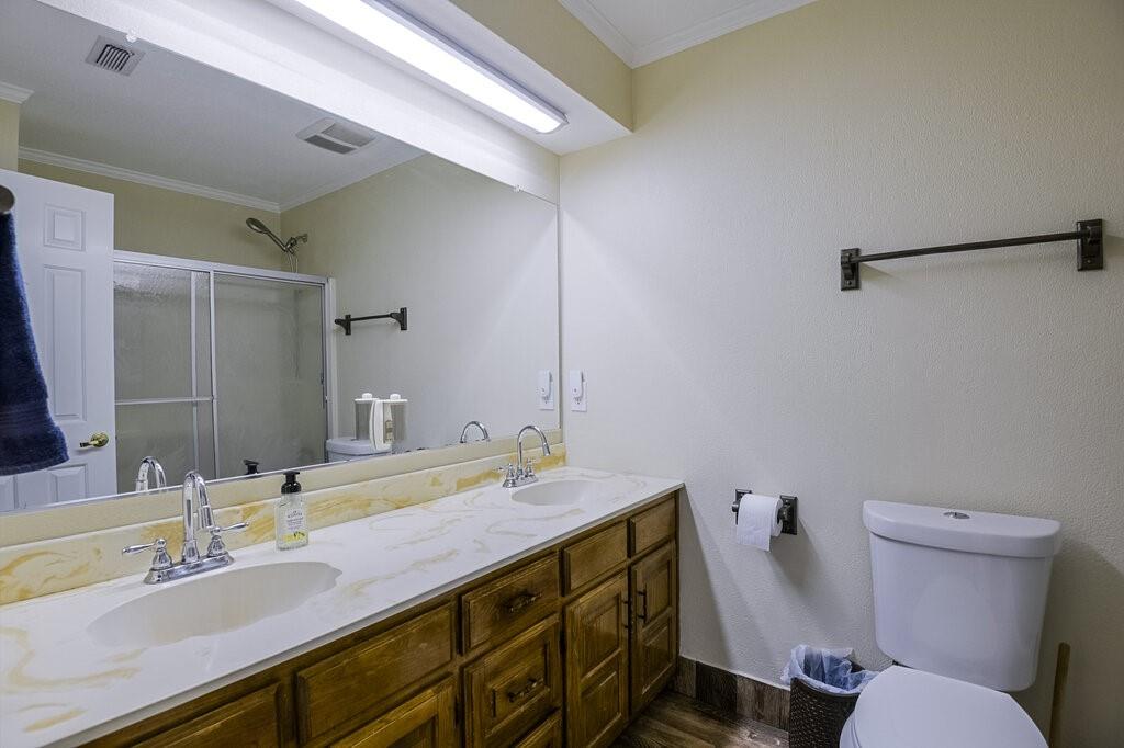 111 Kirk Road Midlothian, TX 76065 - Photo 17 of 40 a bathroom with a sink mirror vanity and toilet