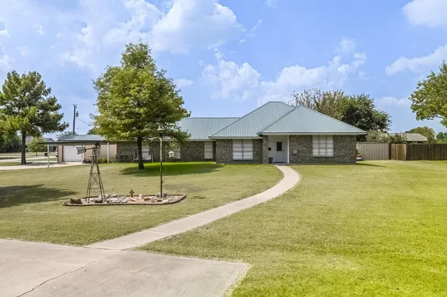 a view of a house with swimming pool and a yard