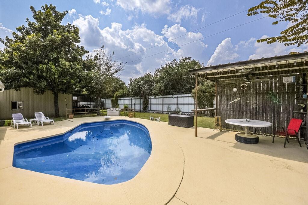 111 Kirk Road Midlothian, TX 76065 - Photo 29 of 40 a swimming pool with outdoor seating and yard