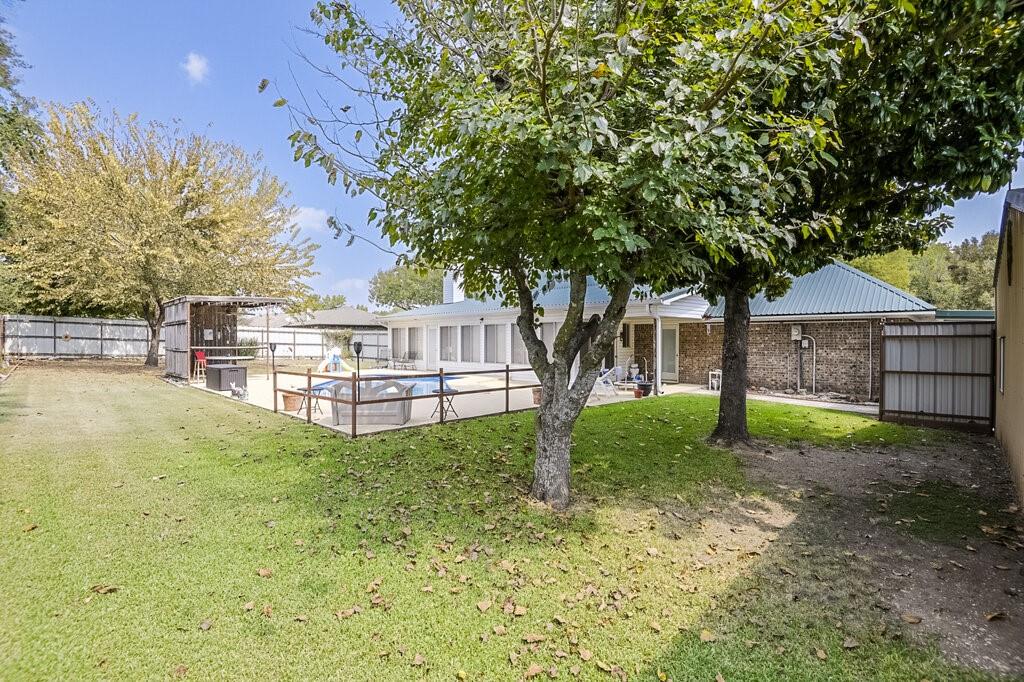 111 Kirk Road Midlothian, TX 76065 - Photo 33 of 40 a view of backyard with large trees and wooden fence