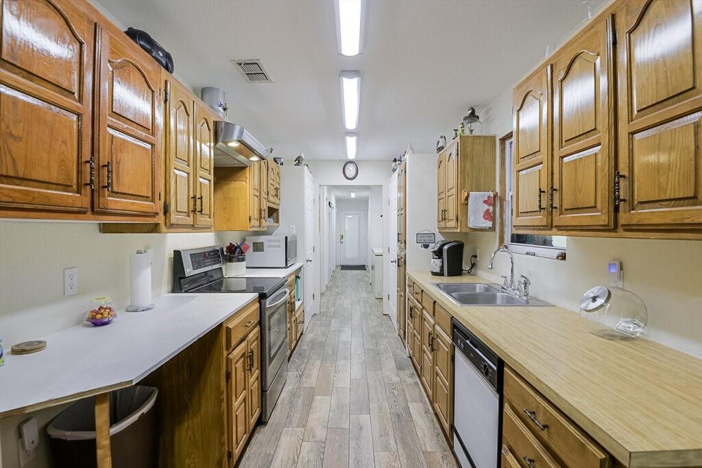 111 Kirk Road Midlothian, TX 76065 - Photo 8 of 40 a kitchen with stainless steel appliances a sink stove and cabinets