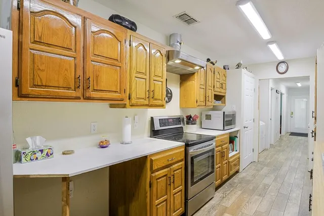 a kitchen with a sink a stove and cabinets