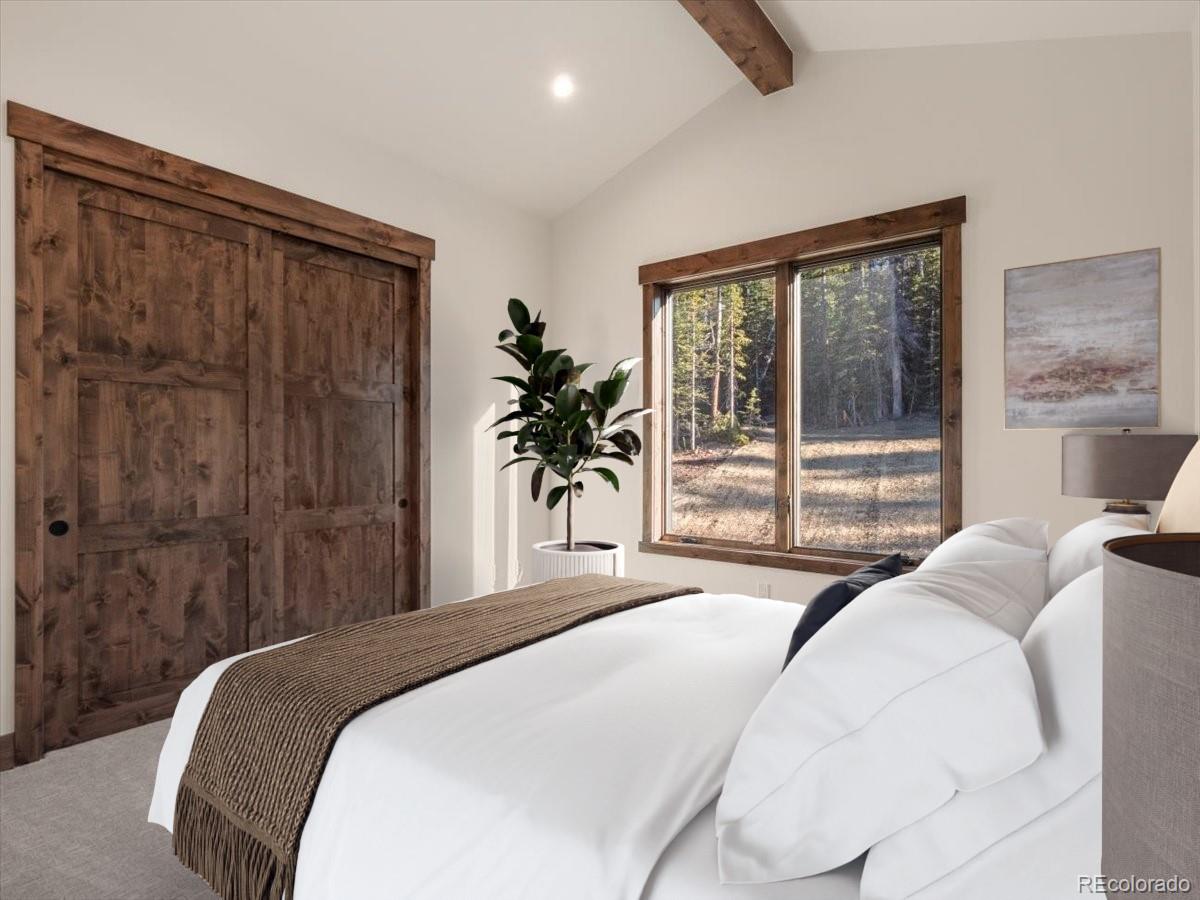 528 Fuller Placer Road Breckenridge, CO 80424 - Photo 19 of 30 a bedroom with a large bed and a large window