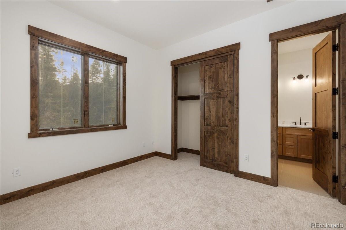 528 Fuller Placer Road Breckenridge, CO 80424 - Photo 22 of 30 an empty room that has a large mirror next to a window