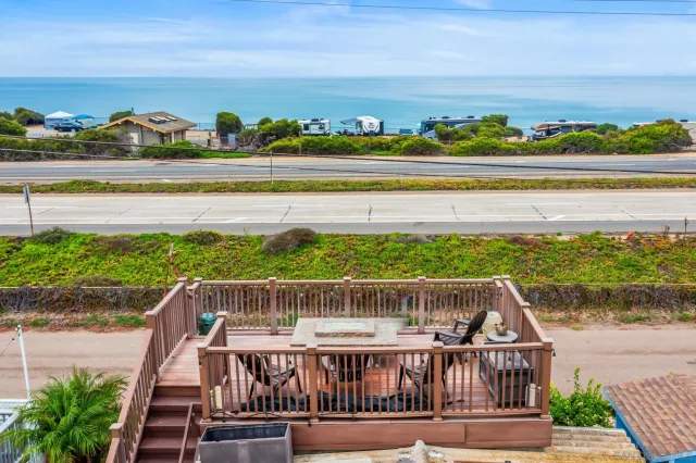 a view of a balcony with wooden floor and city view