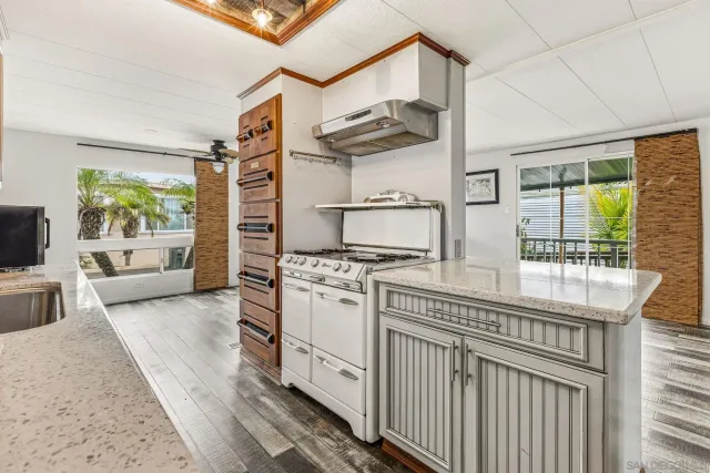 a kitchen with stainless steel appliances granite countertop a stove a sink and a refrigerator