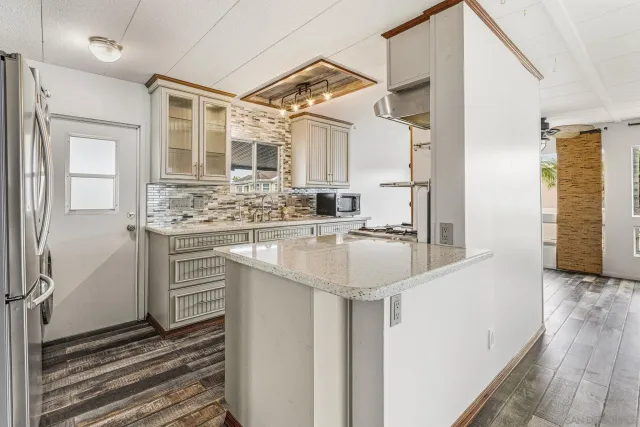 a kitchen with stainless steel appliances a sink stove and refrigerator