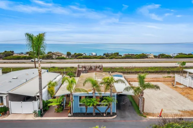 a view of swimming pool with outdoor seating and plants