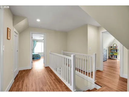 a view of a hallway with wooden floor