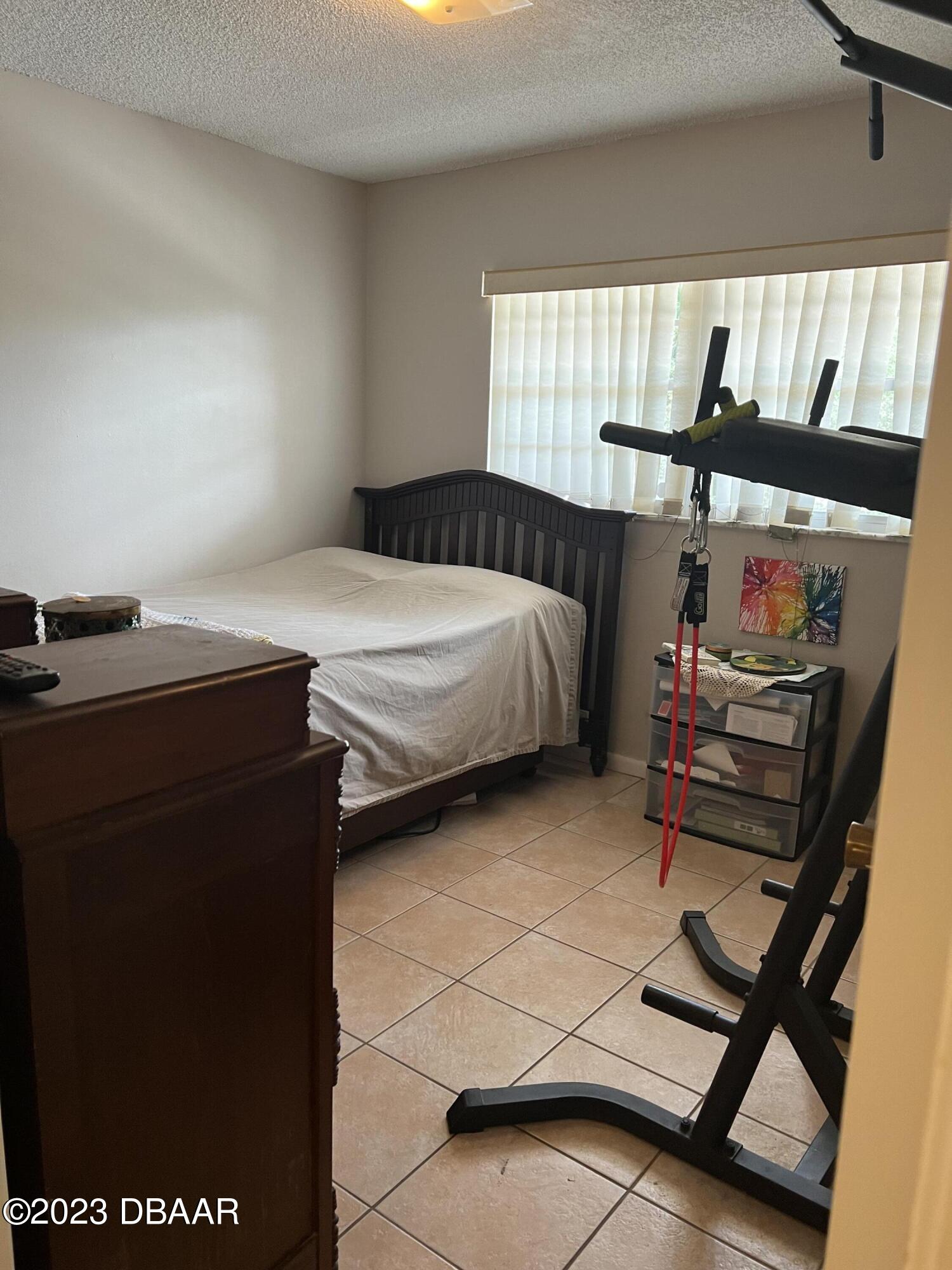 640 North Nova Road, Unit 204 Ormond Beach, FL 32174 - Photo 11 of 17 a bedroom with a bed and a window