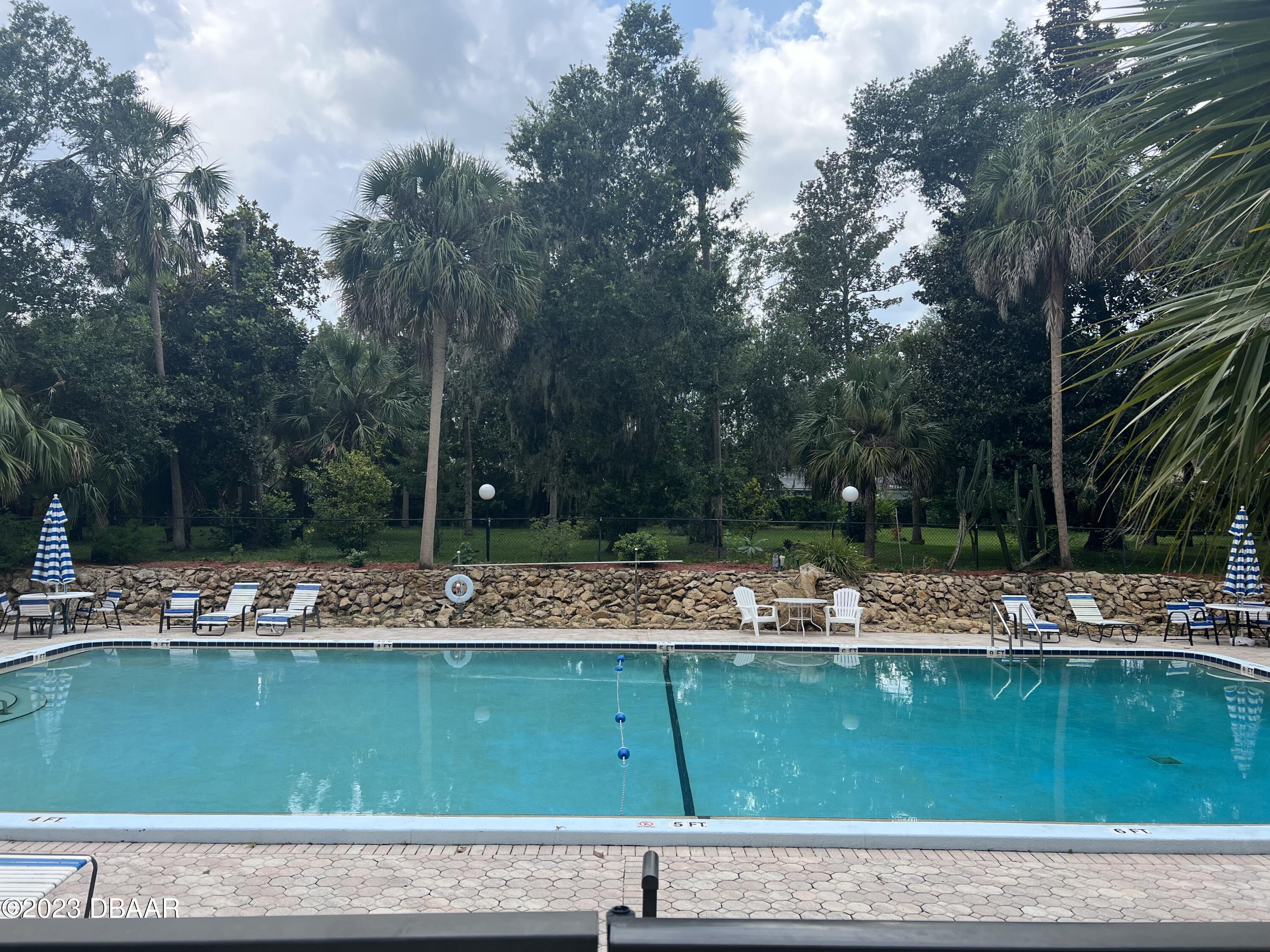 640 North Nova Road, Unit 204 Ormond Beach, FL 32174 - Photo 14 of 17 a view of a lake with a house and trees in the background