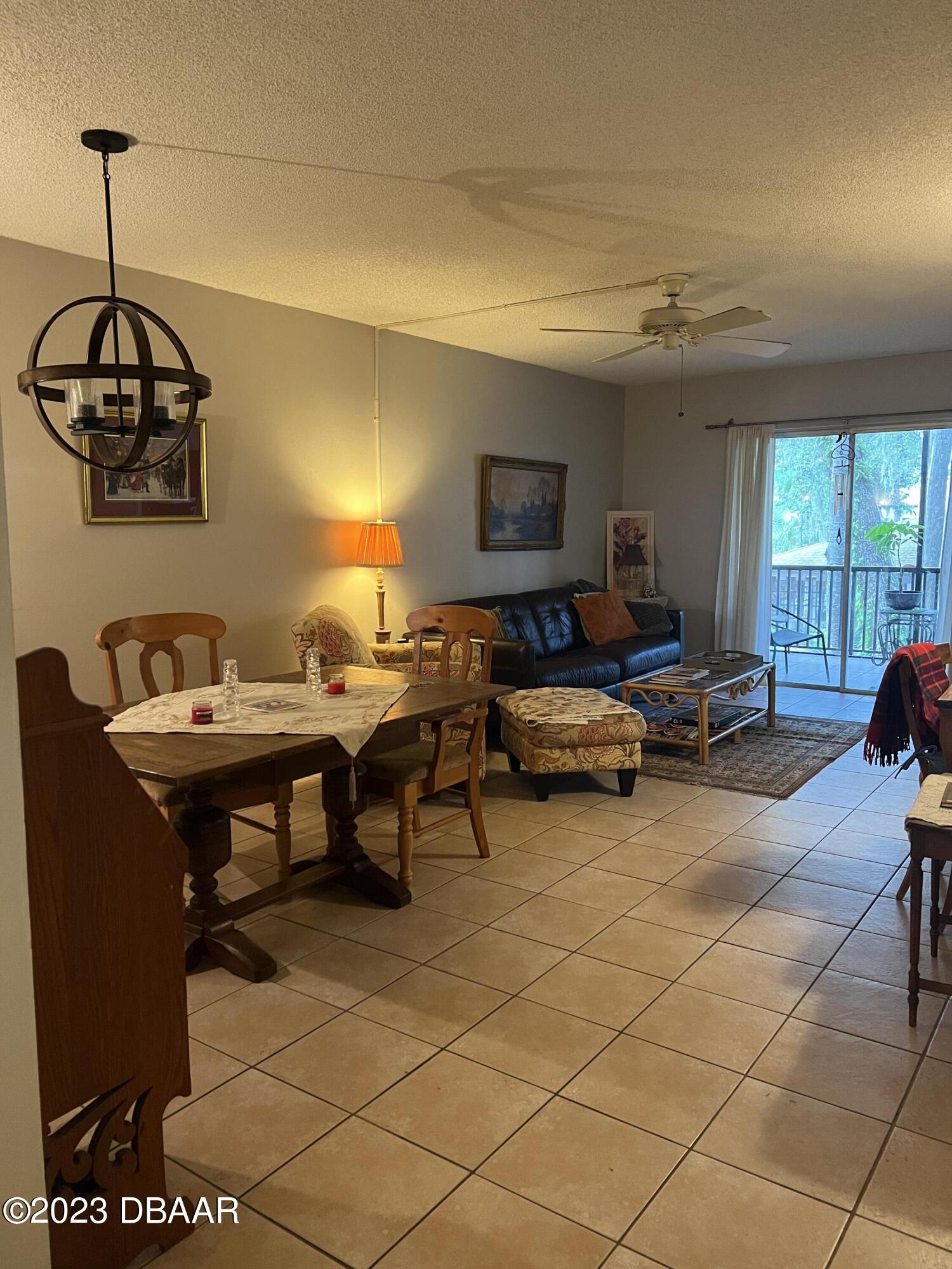 640 North Nova Road, Unit 204 Ormond Beach, FL 32174 - Photo 6 of 17 a living room with furniture a flat screen tv and a window