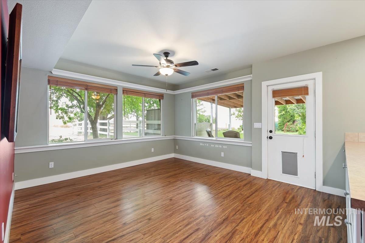 10462 West Lanktree Gulch Road Star, ID 83669 - Photo 30 of 48 Spacious interior room featuring wood-finish flooring, light green walls, and white trim