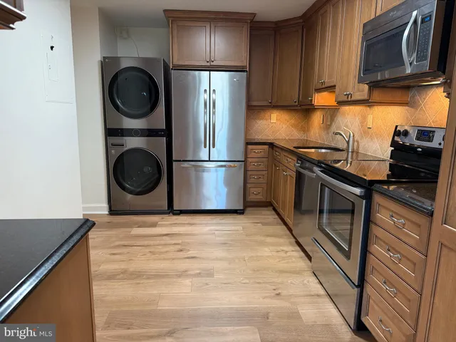 a kitchen with a stove top oven sink and cabinets