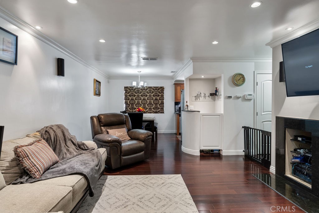 8330 South Somerset Ranch Road, Unit E Paramount, CA 90723 - Photo 1 of 1 a living room with furniture and a wooden floor