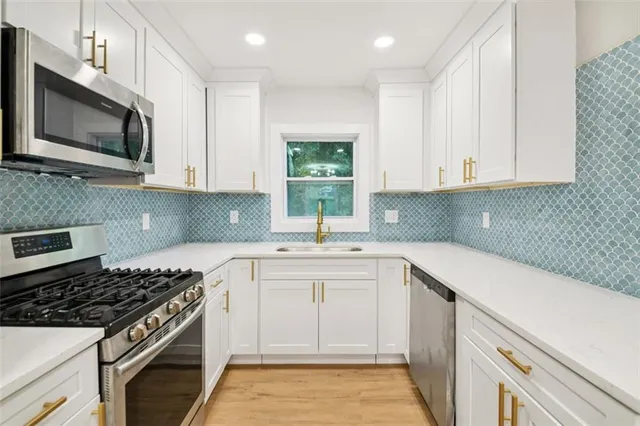 a stove top oven sitting inside of a kitchen