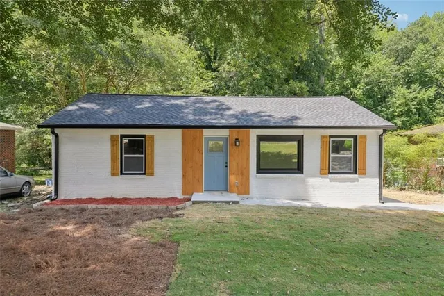 a front view of a house with a garden