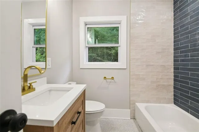 a bathroom with a sink a toilet and a mirror