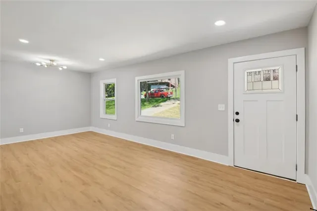 a view of an empty room with wooden floor