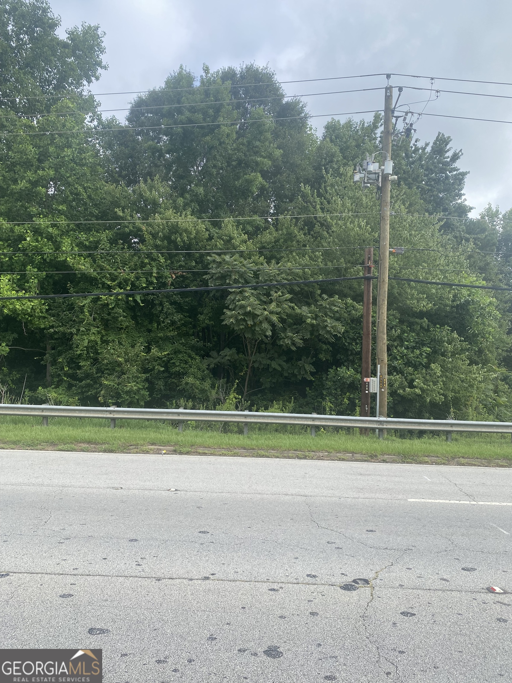 2095 Sigman Road Northwest Conyers, GA 30012 - Photo 3 of 11 a view of a grassy field with trees in the background