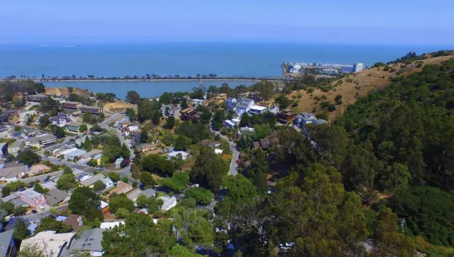 an aerial view of multiple house with a yard