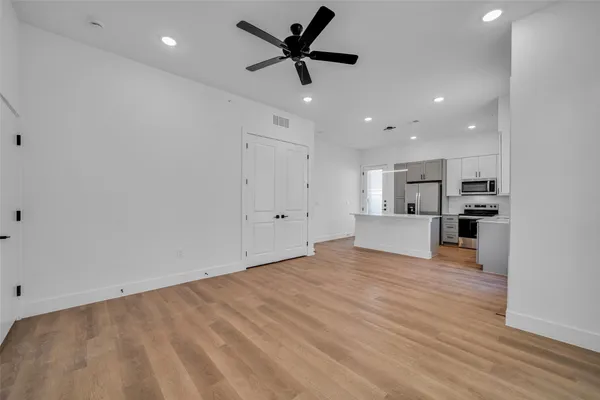 a kitchen with stainless steel appliances a refrigerator stove and microwave