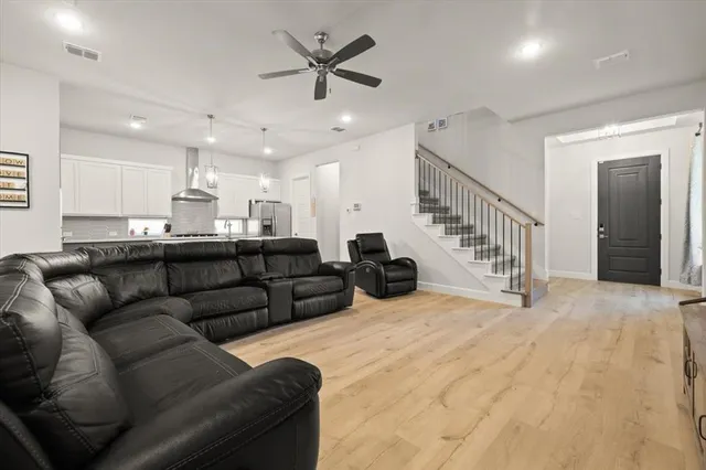 a living room with furniture and kitchen view
