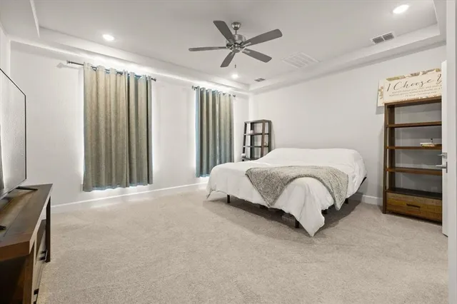 a bedroom with a bed and a ceiling fan