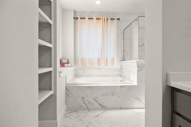 a bath tub sitting in a bathroom next to a window