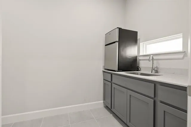 a kitchen with a sink and refrigerator