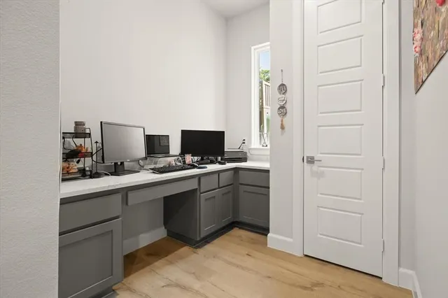 a view of kitchen with refrigerator stove and cabinets