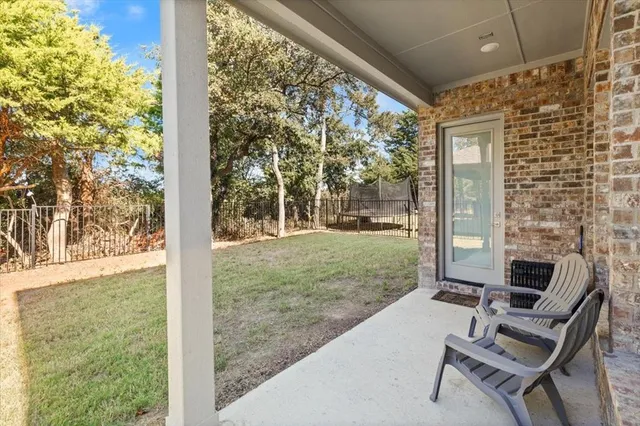 a balcony with couple of chairs and a table