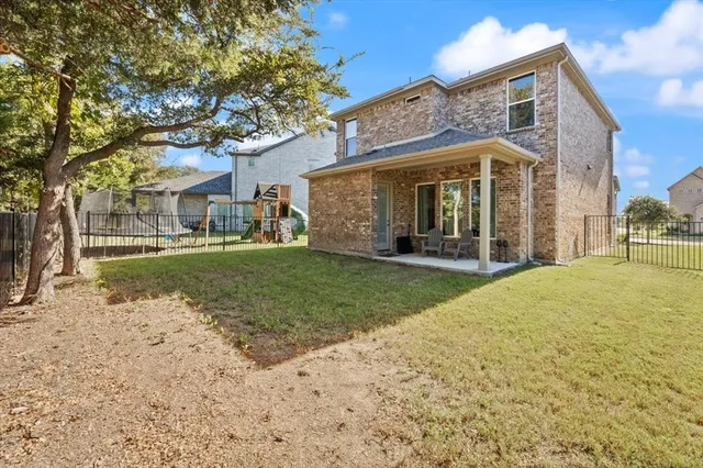 a view of a house with a yard and pathway