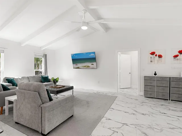 a living room with furniture and a dresser