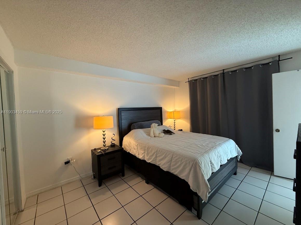 11790 Southwest 18th Street, Unit 1073 Miami, FL 33175 - Photo 12 of 25 a bedroom with a bed and a shower