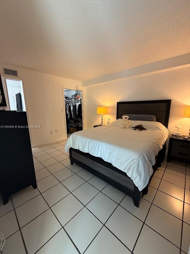 11790 Southwest 18th Street, Unit 1073 Miami, FL 33175 - Photo 13 of 25 a bedroom with a bed and a walk in closet
