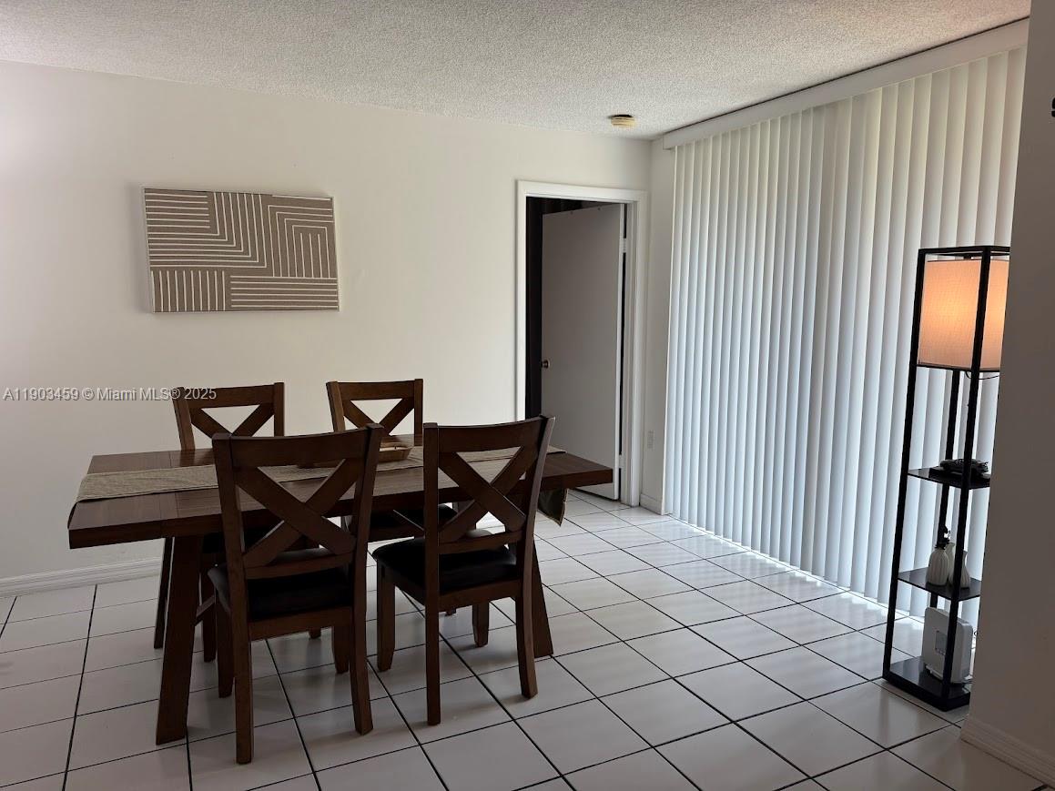 11790 Southwest 18th Street, Unit 1073 Miami, FL 33175 - Photo 9 of 25 a view of a dining room with furniture