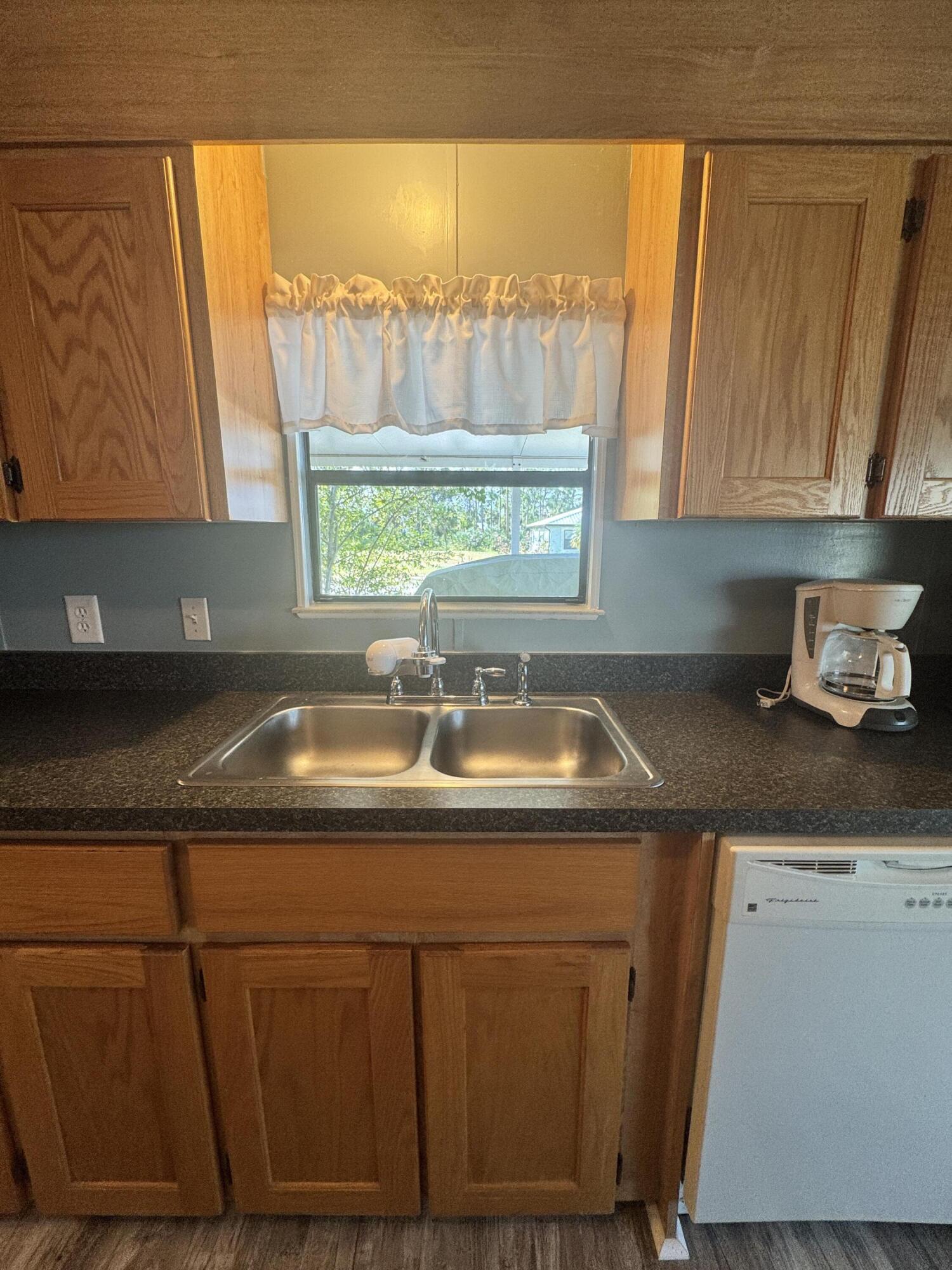 9 San Felipe Fort Pierce, FL 34951 - Photo 12 of 36 a kitchen with a sink and cabinets