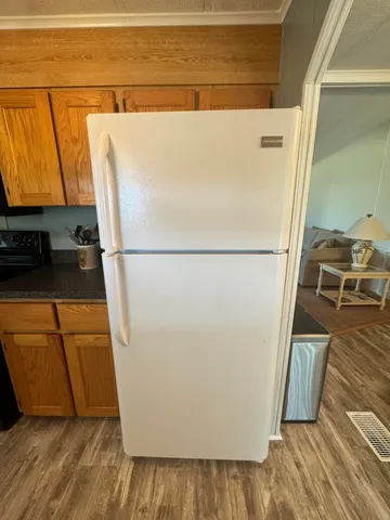 a white refrigerator freezer sitting in a kitchen
