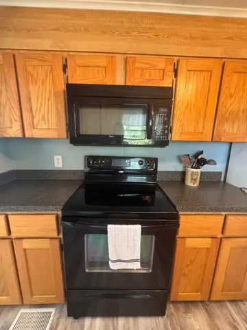 a kitchen with stainless steel appliances granite countertop a stove and cabinets
