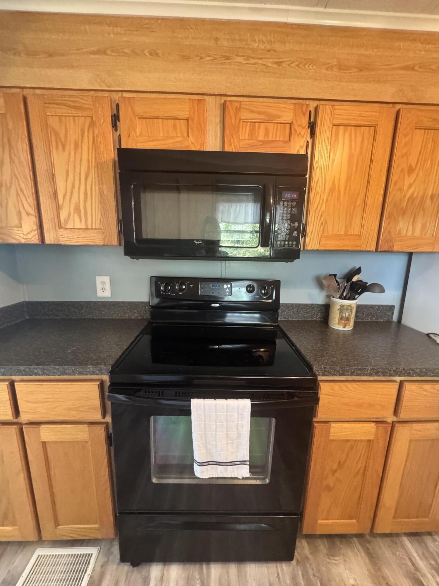 9 San Felipe Fort Pierce, FL 34951 - Photo 14 of 36 a kitchen with stainless steel appliances granite countertop a stove and cabinets
