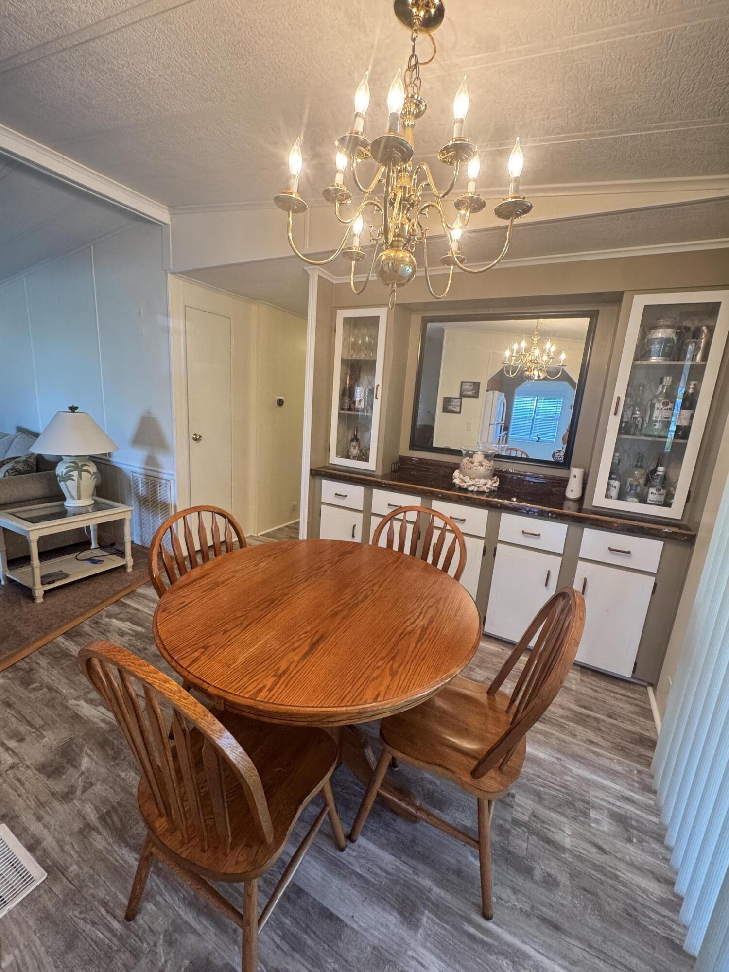 9 San Felipe Fort Pierce, FL 34951 - Photo 18 of 36 a living room with furniture a chandelier and wooden floor